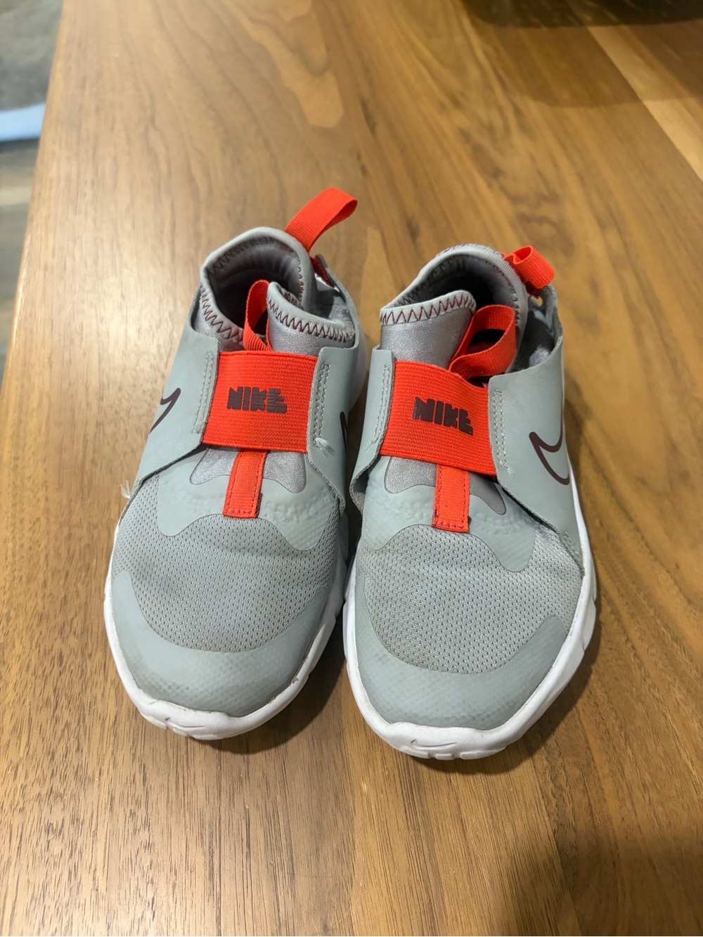 Nike Kids Slip-On Sneakers in Light Gray with Bright Orange Straps